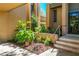 Charming front entrance with stone steps and a garden full of plants and greenery to the door at 601 W Old Us Highway 441 # 9B, Mount Dora, FL 32757