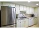 Well-maintained kitchen with stainless steel refrigerator and bright white cabinetry at 601 W Old Us Highway 441 # 9B, Mount Dora, FL 32757