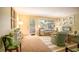 Cozy living room with large windows, comfortable seating, and bright natural light at 601 W Old Us Highway 441 # 9B, Mount Dora, FL 32757