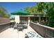 Outdoor patio with grill, dining set, sun umbrella, and lounging chair at 601 W Old Us Highway 441 # 9B, Mount Dora, FL 32757