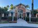 Community clubhouse showcasing a brick facade, arched entryway, and lush landscaping at 6274 Bristol Channel Way, Orlando, FL 32829