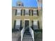 Townhouse exterior features a private entrance with black door, white rails, three windows, and black shutters at 6274 Bristol Channel Way, Orlando, FL 32829