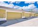 A row of garages features three garage doors with ample parking space for homeowners at 6274 Bristol Channel Way, Orlando, FL 32829