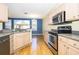 Kitchen features stainless steel appliances, sleek countertops, modern cabinets, and light-filled breakfast nook at 6274 Bristol Channel Way, Orlando, FL 32829