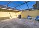 Enclosed patio area featuring neutral toned walls and a screened in roof with outdoor furniture at 6274 Bristol Channel Way, Orlando, FL 32829