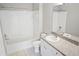Clean bathroom with white tile surround tub and vanity with granite counter at 6364 Raleigh St # 1615, Orlando, FL 32835