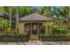 View of the exterior of the community clubhouse surrounded by lush landscaping at 6364 Raleigh St # 1615, Orlando, FL 32835