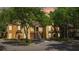 View of townhome nestled among trees and a landscaped yard at 6364 Raleigh St # 1615, Orlando, FL 32835