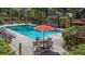 Community pool area features lounge chairs, tables, and umbrellas at 6364 Raleigh St # 1615, Orlando, FL 32835
