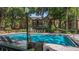 Community pool area with lounge chairs at 6364 Raleigh St # 1615, Orlando, FL 32835