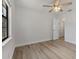 Spacious bedroom with ceiling fan, closet, and sleek floors at 6713 Cherry Rd, Ocala, FL 34472