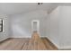 Bright bedroom with vaulted ceilings, light wood floors, neutral walls, and access to the bathroom at 6713 Cherry Rd, Ocala, FL 34472