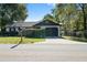 Charming single-story home featuring a one-car garage, tidy landscaping, and neutral colors at 6713 Cherry Rd, Ocala, FL 34472