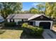 Charming single-story home featuring a one-car garage, tidy landscaping, and neutral colors at 6713 Cherry Rd, Ocala, FL 34472