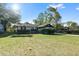 View of single-story home with well-kept lawn and landscaping plus a convenient, attached one-car garage at 6713 Cherry Rd, Ocala, FL 34472