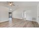 Bright living room featuring light wood floors, neutral walls, ceiling fan and easy access to the bedrooms at 6713 Cherry Rd, Ocala, FL 34472