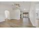 Bright living room with light wood floors, neutral walls, ceiling fan and view of the back patio at 6713 Cherry Rd, Ocala, FL 34472