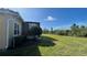 Expansive backyard with lush greenery and a covered lanai, offering a private and serene outdoor oasis at 801 San Raphael St, Poinciana, FL 34759