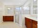 Bright primary bathroom featuring double sinks, walk-in shower and natural light at 801 San Raphael St, Poinciana, FL 34759