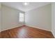 Bright bedroom with sleek wood floors and a sunlit window offering a cozy and inviting space at 801 San Raphael St, Poinciana, FL 34759