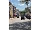Charming community street featuring paver road, colorful buildings, and parked golf carts at 801 San Raphael St, Poinciana, FL 34759