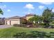 Beautiful home with a well-maintained lawn and landscape, paired with a spacious three-car garage and tiled roof at 801 San Raphael St, Poinciana, FL 34759