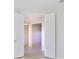 Hallway boasts an open doorway and neutral color scheme at 801 San Raphael St, Poinciana, FL 34759