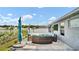 Outdoor patio with stylish outdoor furniture and an umbrella overlooking the lake at 8043 Brookeshire Dr, Lakeland, FL 33809