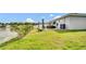 Lawn that leads to the lake is adjacent to a patio with outdoor furniture at 8043 Brookeshire Dr, Lakeland, FL 33809