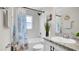 Bright bathroom featuring a shower over the tub and vanity with granite countertop at 8043 Brookeshire Dr, Lakeland, FL 33809