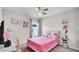 Cozy bedroom features pink accents, carpet flooring, and a ceiling fan at 8043 Brookeshire Dr, Lakeland, FL 33809