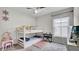 A bedroom with a white bunk bed, plush carpet and a window for natural light at 8043 Brookeshire Dr, Lakeland, FL 33809
