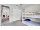 A bedroom features a bunk bed next to a large closet with a ceiling fan for comfort at 8043 Brookeshire Dr, Lakeland, FL 33809