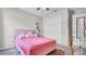 Comfortable bedroom featuring pink accents, carpet flooring, and closet at 8043 Brookeshire Dr, Lakeland, FL 33809