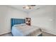 A serene bedroom features a comfortable bed, complemented by a ceiling fan and soft lighting at 8043 Brookeshire Dr, Lakeland, FL 33809