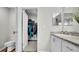 A view of the walk-in closet with custom shelves and an adjoining bathroom at 8043 Brookeshire Dr, Lakeland, FL 33809