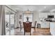 Contemporary dining area featuring glass table, stylish chairs, and access to the kitchen at 8043 Brookeshire Dr, Lakeland, FL 33809