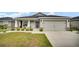 Charming home with a two-car garage, manicured lawn, and a welcoming front porch at 8043 Brookeshire Dr, Lakeland, FL 33809