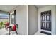 A welcoming porch features comfortable seating and a stylish front door, creating a cozy entrance at 8043 Brookeshire Dr, Lakeland, FL 33809