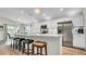 A kitchen with a breakfast bar featuring marble countertops, stainless steel appliances, and pendant lighting at 8043 Brookeshire Dr, Lakeland, FL 33809