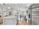 The kitchen's marble-topped peninsula extends into the dining area, featuring stainless steel appliances and ample lighting at 8043 Brookeshire Dr, Lakeland, FL 33809