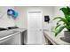 Bright laundry room featuring front loading washer and dryer, overhead shelving and a granite counter top at 8043 Brookeshire Dr, Lakeland, FL 33809