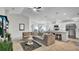 Spacious open-concept living room connected to kitchen with stainless appliances and bar seating at 8043 Brookeshire Dr, Lakeland, FL 33809