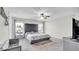 A comfortable main bedroom features a plush, tufted headboard, ceiling fan and a soft gray color palette at 8043 Brookeshire Dr, Lakeland, FL 33809