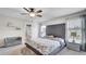 The main bedroom features a gray tufted headboard, ceiling fan, and an ensuite bathroom at 8043 Brookeshire Dr, Lakeland, FL 33809