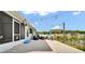 Back patio with string lights and outdoor furniture overlooking the lake at 8043 Brookeshire Dr, Lakeland, FL 33809