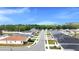A picturesque streetscape reveals homes nestled between lush trees and reflecting the clear blue sky at 8043 Brookeshire Dr, Lakeland, FL 33809
