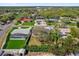 An aerial view showcases the property, including lush landscaping, and neighborhood at 822 Oakview Dr, New Smyrna Beach, FL 32169
