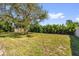 Expansive backyard features lush greenery, mature trees, and a tranquil setting at 822 Oakview Dr, New Smyrna Beach, FL 32169