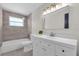 Updated bathroom featuring sleek vanity, tub, and tiled shower at 822 Oakview Dr, New Smyrna Beach, FL 32169